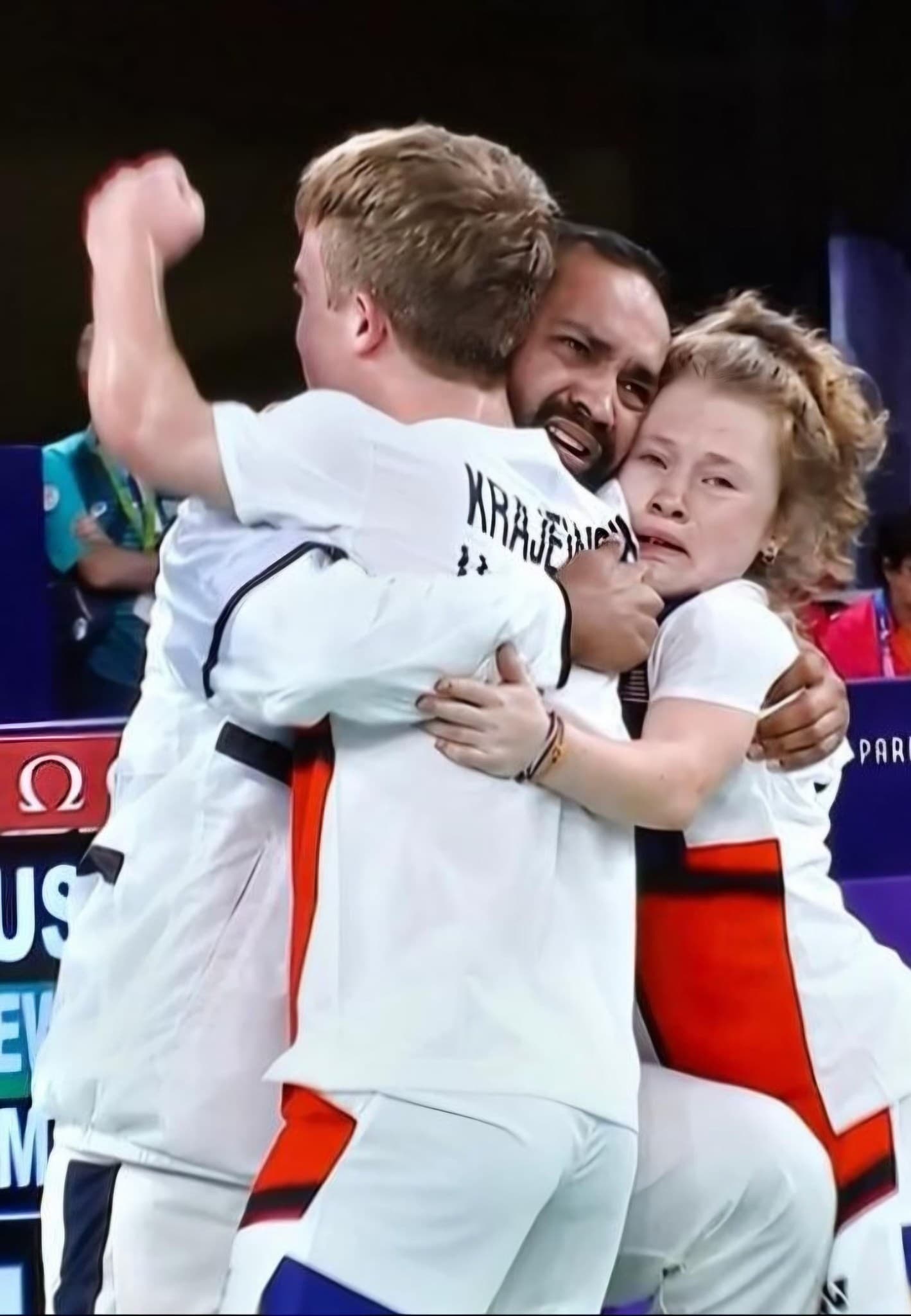 Miles Krajewski and Jayci Simon embracing Coach Abhishek Ahlawat courtside after winning silver at the Paris 2024 Paralympic Games